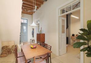 a kitchen and dining room with a wooden table and chairs at Timeless Gem in Old Nicosia in Nicosia