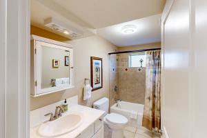 a bathroom with a sink and a toilet and a shower at Crystal Rose Home in Lincoln City +22 photos