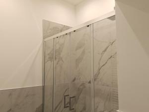 a shower stall with a marble wall at Venice Tourist House in Venice +104 photos