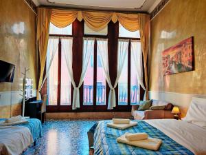 a bedroom with two beds and a large window at Venice Tourist House in Venice