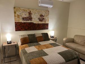 a bedroom with a bed and a painting on the wall at Karakter Inmuebles, VF Department in Reynosa