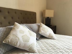 a bedroom with a bed with two pillows on it at Azzaí Bellas Artes in Santiago +116 photos
