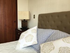 a bedroom with a bed with two pillows on it at Azzaí Bellas Artes in Santiago