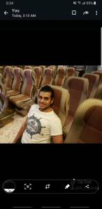 a man sitting in a seat in an auditorium at Jeep grand Cherokee limited for rent ful insurance without drivers in Madinaty