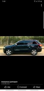 a black car parked next to a fence at Jeep grand Cherokee limited for rent ful insurance without drivers in Madinaty