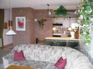 a living room with a couch and a kitchen at Appartment 3737 in Tossens in Tossenserdeich