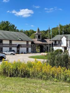 a building with a car parked in a parking lot at #146 Golf, SkI, Pool Pass Walk to hill in Mancelona +13 photos