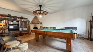 a living room with a pool table and a fireplace at Casa Angelino in Lagarteira