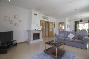 a living room with a couch and a fireplace at Villa Maresia in Patroves