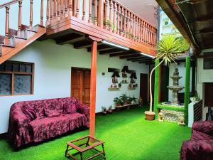 a living room with a couch and a staircase at Taita wasi in Cajamarca