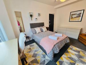 a bedroom with a bed and a couch at Room 1 Shared House in L7 in Liverpool
