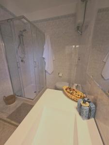 a bathroom with a shower and a pizza on a tub at Villa Mary Holiday Home Near Villasimius in Quartu SantʼElena +44 photos