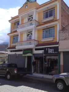 a truck parked in front of a building at Samana Hostal in Otavalo