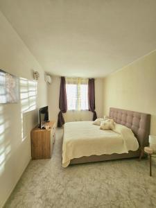 a bedroom with a bed and a television in it at Villa Mary Holiday Home Near Villasimius in Quartu SantʼElena