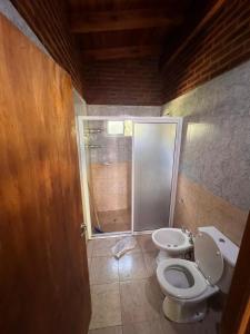 a bathroom with a toilet and a sink at Cabañas San Lorenzo in San Lorenzo +7 photos