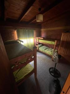 a room with three bunk beds in a cabin at Cabañas San Lorenzo in San Lorenzo