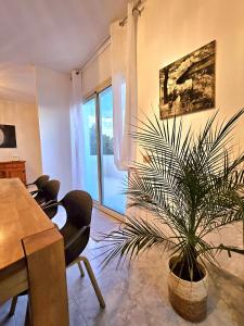 a dining room with a table and a potted plant at Villa Mary Holiday Home Near Villasimius in Quartu SantʼElena