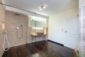 a bathroom with a shower with a glass door at Villa Agni in Dänschendorf +15 photos