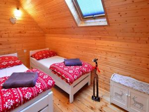a room with two beds in a log cabin at Holiday cottages, close to the beach, Ustronie in Ustronie Morskie