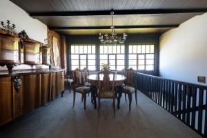 a dining room with a table and chairs and a chandelier at Florian's Haus in Cisnădioara