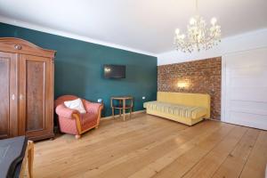 a living room with a couch and a chair at Florian's Haus in Cisnădioara +102 photos