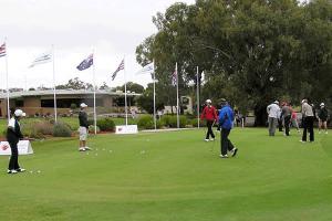 a group of people playing golf on a golf course at Tocumwal Early Settlers Motel in Tocumwal