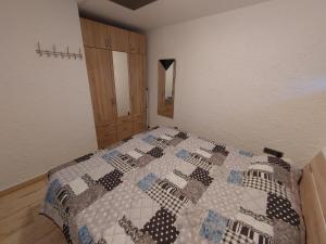 a bedroom with a bed with a quilt on it at Appartment 129 in Tossens in Stick +8 photos
