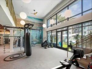 a fitness room with a gym with a treadmill at Spacious 2 Bedroom Apartment Near Disneyland and Anaheim Convention Center in Anaheim