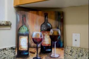 a painting of three bottles and two glasses of wine at Spacious 2 Bedroom Apartment Near Disneyland and Anaheim Convention Center in Anaheim
