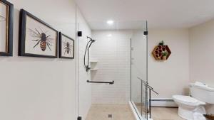 a bathroom with a shower and a toilet at Sunrise - W Glade K-5 in Killington +26 photos