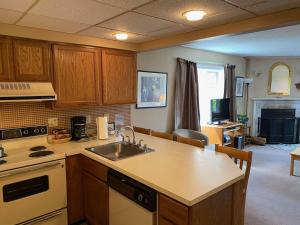 a kitchen with a sink and a counter top at Pico Village Resort D209 in Killington +6 photos