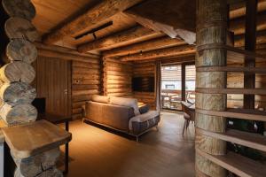 a living room with a couch in a log cabin at Aurum Cabins in Zlatibor