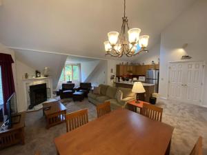 a living room with a table and a dining room at Pico Village Resort G301 in Killington