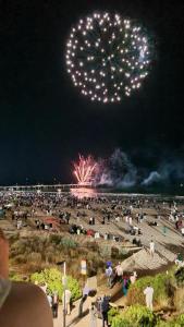 a crowd of people watching a fireworks show at night at Absolute Beachfront at the Pier Glenelg in Adelaide