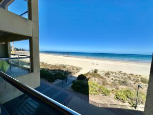 a view of the beach from the balcony of a building at Absolute Beachfront at the Pier Glenelg in Adelaide