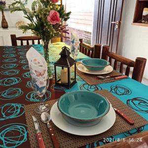 a table with two plates and bowls on top at Villa Anita Spa in Piriápolis