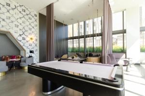 a large billiard room with a pool table at Stunning 3 Bedroom High-Rise with Pool, Spa, and Rooftop Views in Los Angeles +52 photos