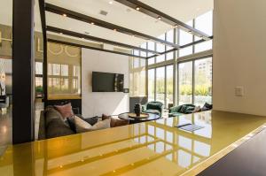 a living room with a couch and a table at Stunning 3 Bedroom High-Rise with Pool, Spa, and Rooftop Views in Los Angeles