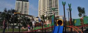 a playground in a park with children playing on it at Richone Maluri Private Hotel in Kuala Lumpur