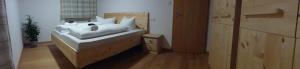 a bedroom with a bed with white pillows on it at Ferienwohnung Uferweg in Fischbachau