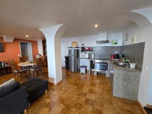 a kitchen and living room with a couch and a table at HOME4U in Horta