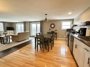 a kitchen and dining room with a table and chairs at 2BR Condo Downtown SWH w/ Ocean Views [Driftwood] in Southwest Harbor