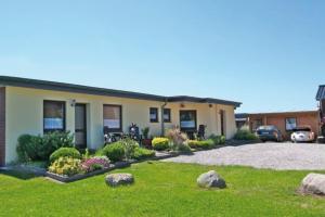 a house with rocks in front of a yard at "Ferienhof Alte Mühle" W 5 in Bannesdorf +2 photos