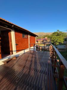una terraza de madera con bancos en la parte superior de un edificio en Casa Fiorenza, en Merlo