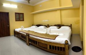 two beds in a room with white pillows at Dream Promenade Beach Side in Puducherry +51 photos