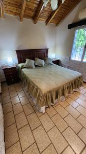 a bedroom with a large bed in a room at El Sauce, casa de campo & golf in Santa Lucía