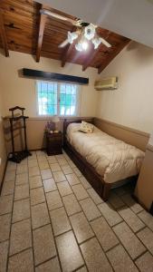 a bedroom with a bed and a ceiling fan at El Sauce, casa de campo & golf in Santa Lucía