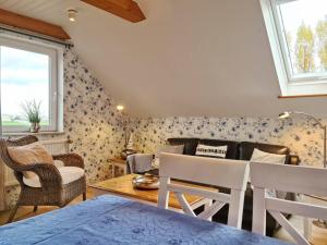 a living room with a couch and a table at MeerBlüte in Vadersdorf