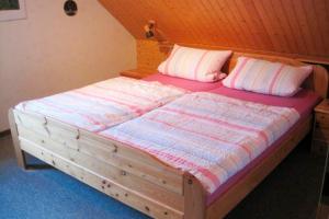 a large wooden bed in a room at Ferienhof Ralf Becker Nr2 in Westfehmarn