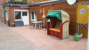 a building with a patio with a canopy and a table at Ferienwohnung Max 1 in Grube